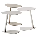 Three Modern Light Toned Side Tables With Slim Legs And Minimalist Design