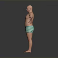 Bald Shirtless Man Standing With Arms Outstretched In Green Striped Shorts Against Gray Background