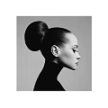 Profile View Portrait of a Woman With Sleek High Bun Hairstyle and High Neck Top