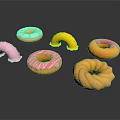 Colorful Frosted Donuts With Sprinkles And Assorted Shapes On White Surface