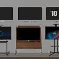 Multiple Televisions Mounted on Wall and Stands with Black and Lit Screens Displaying