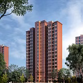 Modern High Rise Residential Building Red Brick Exterior Surrounded By Green Trees Under Blue Sky