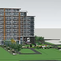 Modern Multi Story Building Exterior With Large Glass Windows Surrounding Greenery And Lawn Area
