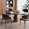 Modern Dining Area With Round Wooden Table Black Chairs And Green Plants