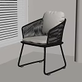 Modern Minimalist Rattan Leisure Chair With Black Frame And Light Cushion In Bright Room
