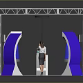 Exhibition Booth With White Metal Frame Blue Curved Structures Orange Floor And Woman At