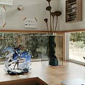 Cozy Study Room Interior With Large Windows Overlooking Green Trees And Bookshelves Filled With Books