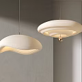 Two Modern Curved Fabric Pendant Chandeliers With Soft Lighting In Minimalist Interior