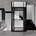 Modern Glass Elevator With Black Frame And Marble Staircase In Luxury Interior
