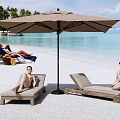 People Relaxing On Beach Lounge Chairs Under Umbrella With Palm Trees And Blue Ocean