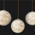 Three Ivory White Spherical Pendant Lights With Moon Surface Texture On Dark Wall