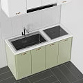 Modern Kitchen Sink with Light Green Cabinets Gold Handles and Black Countertop