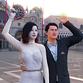 Couple In Wedding Gown And Suit Waving At Venetian Plaza
