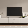 White TV Stand With Flat Screen TV Decorative Vase Fruit Bowl And Artwork