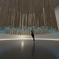 Stunning Hanging Art Installation With Long Strips Blue Lights And Person Underneath