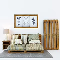 Two-seater Sofa With Striped Checkered Cushions Wooden Side Table Lamp And Wall Art