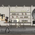 Public Office Space With Person At Desk Photography Equipment Shelves Bottles Lighting And Green Plants