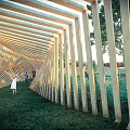 Wooden Strip Archway Garden Landscape With Lush Green Grass And People Walking