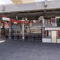 Outdoor Restaurant Dining Area With Hanging Signs Tables Chairs And Storefronts