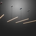 Modern Linear Pendant Lights Hanging In Dark Room With Warm Glow
