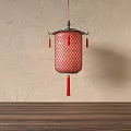 Red Mesh Chinese Lantern With Metal Frame And Tassels Hanging On Beige Wall