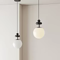 Modern Pendant Lights With White Spherical Shades And Black Tops