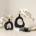 Modern Black Vases With White Orchid Flowers Stack Of Books Open Book And Coffee Cup