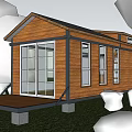 Wooden Cabin Vacation Rental With Front Deck Large Windows And Green Lawn Surrounded By Trees