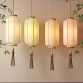 Traditional Hanging Lanterns With Tassels And Warm Yellow Light Near Bamboo Leaves
