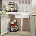 Green Kitchen Cabinets With Open Doors Featuring Storage Rack Inside Sink And Marble Countertop