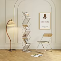 Modern Metal Bookshelf With Books And Coffee Cup Near Chair Floor Lamp And Wall Art
