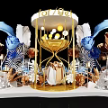 Artistic Decorative Installation With Gold Hourglass Structure Blue Gold Flowers White Leaves And Soft Lighting