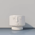 Minimalist White Ceramic Decorative Ornament Set With Facial Features On Gray Surface