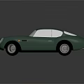 Vintage Green Sports Car With Rounded Body White Headlights And Silver Wheels