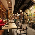 Cozy Restaurant Interior With Decorative Brick Walls Star Shaped Pendant Lights Long Bar And Diners