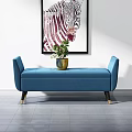 Blue Upholstered Ottoman Bench With Potted Plant And Wall Art Decor