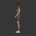 Woman in Gray Sports Bra and Shorts Standing with White Sneakers on Gray Background