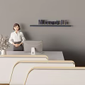 Professional Office Reception Area With Female Receptionist White Desk Minetti Sign Vase And Computer Monitor