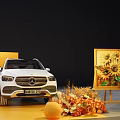 Automotive Exhibition Display With White Cars Orange Backdrop And Decorative Fruits