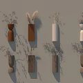 Minimalist Wall Decor With Various Shaped Vases Holding Dried Flowers On Beige Wall