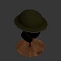 Green Military Style Helmet With Wide Brim And Brown Strap On Mannequin Head