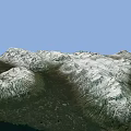 Mountainous Terrain With Snow Covered Peaks And Green Forested Valleys