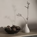 White Vase Holding Dried Branches And Dark Bowl Of Pears On Wooden Tabletop