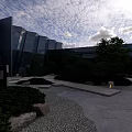 Modern Courtyard Garden With Greenery Shrubs Stones Gravel Path Lighting And Blue Sky