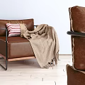 Brown Leather Single Sofa with Red White Striped Pillow Beige Blanket and Black Metal Frame