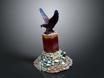 Eagle Sculpture Perched On Red Pillar With Colorful Stones At Base 3d model