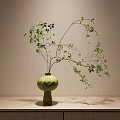 Green Ceramic Vase With Fresh Green Leaves And Branches On Wooden Cabinet Light Wall Background