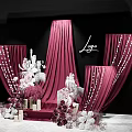 Elegant Wedding Decoration Setup With Red Curtains White Chandelier And Floral Arrangements Against Black Backdrop
