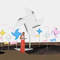 Popular Photo Spot With Giant White Windmill And Colorful Windmills On Beach With Blue Sky