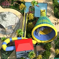 Vibrant Amusement Park Featuring Yellow Blue Water Slide Red Roof Building Palm Trees And Greenery